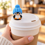 Classic Penguin topper on a coffee cup lid