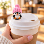 Classic Penguin with pink hat on a coffee cup lid