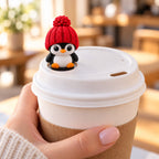 Classic Penguin with red hat on a coffee cup lid