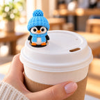 Cozy Scarf Penguin topper on a coffee cup lid