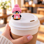 Cozy Scarf Penguin with pink hat on a coffee cup lid