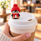 Cozy Scarf Penguin with red hat on a coffee cup lid