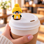 Cozy Scarf Penguin with yellow hat on a coffee cup lid