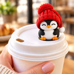 Sleepy Penguin with red hat on a coffee cup lid